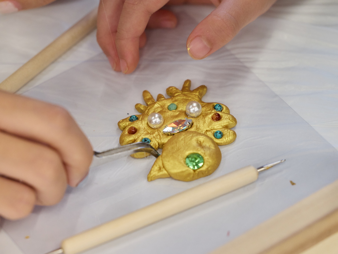 Participants are making their own brooches