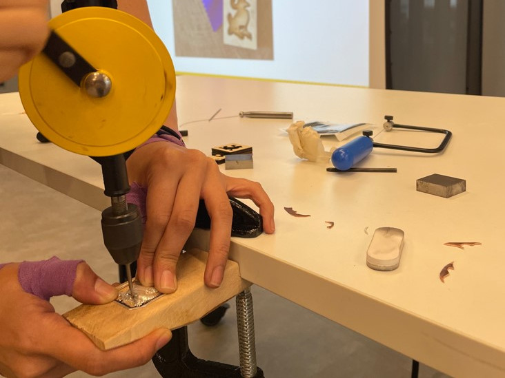 Participants are making their own jewellery