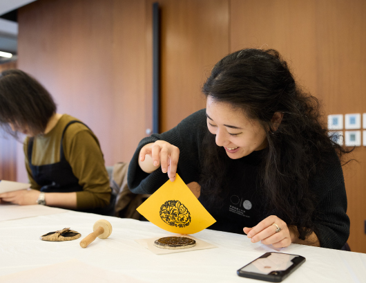 Participant creates her own print with a pattern that symbolises good luck in traditional Chinese culture.