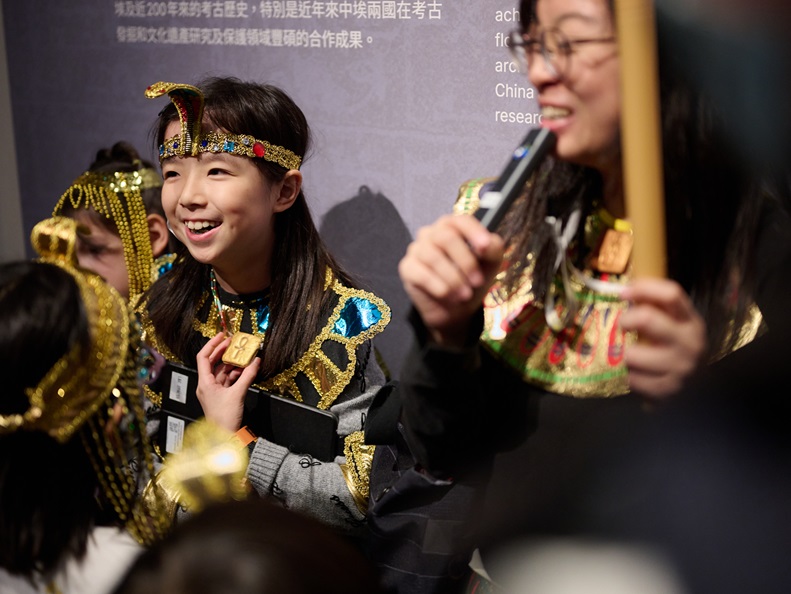 ​  Participants in their dress-up  costumes interacting with tutor during guided tour.
