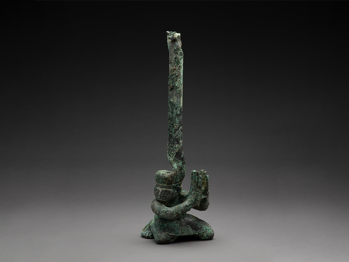 Kneeling figure with twisted head